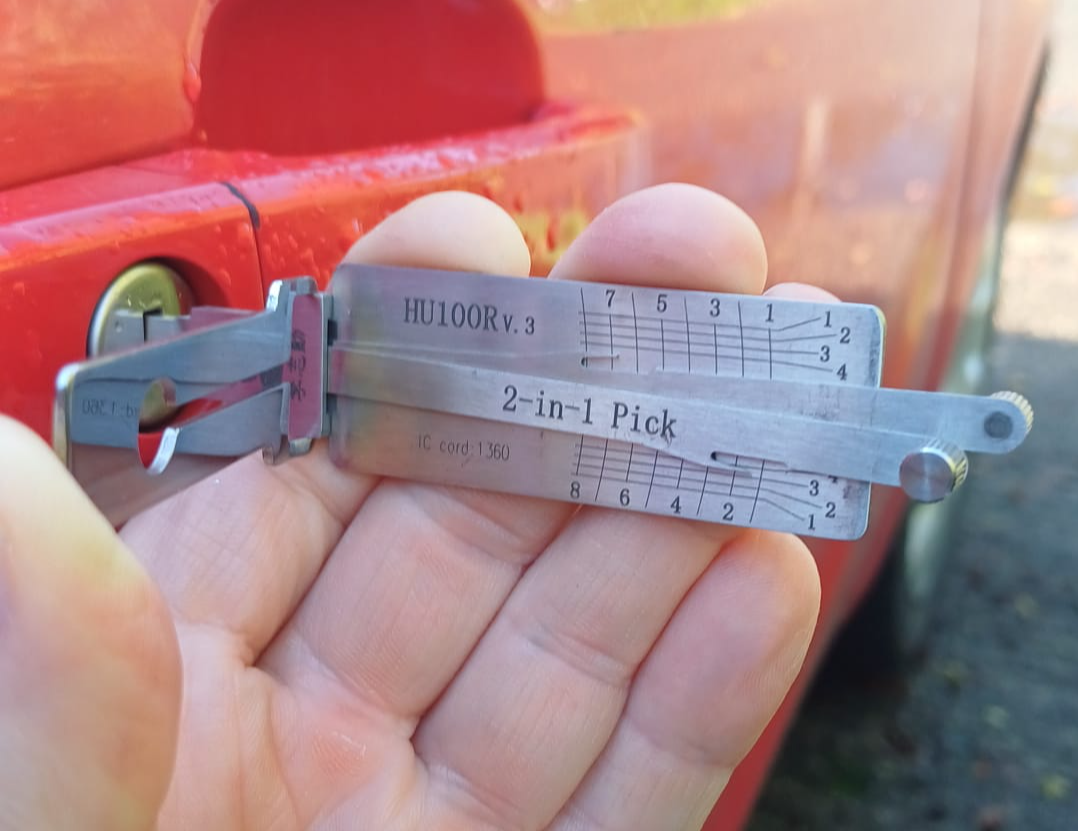 Lock picking tool being used on a car door